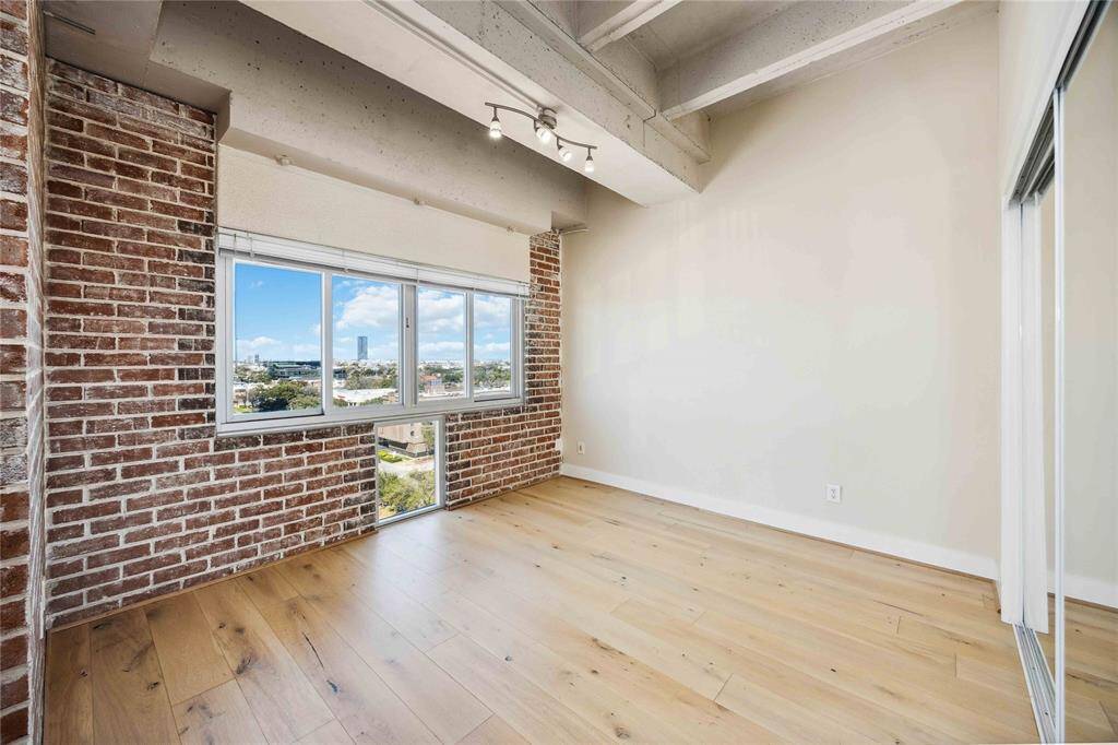 The brick accent wall in the bedroom is a striking focal point, and look at that view!