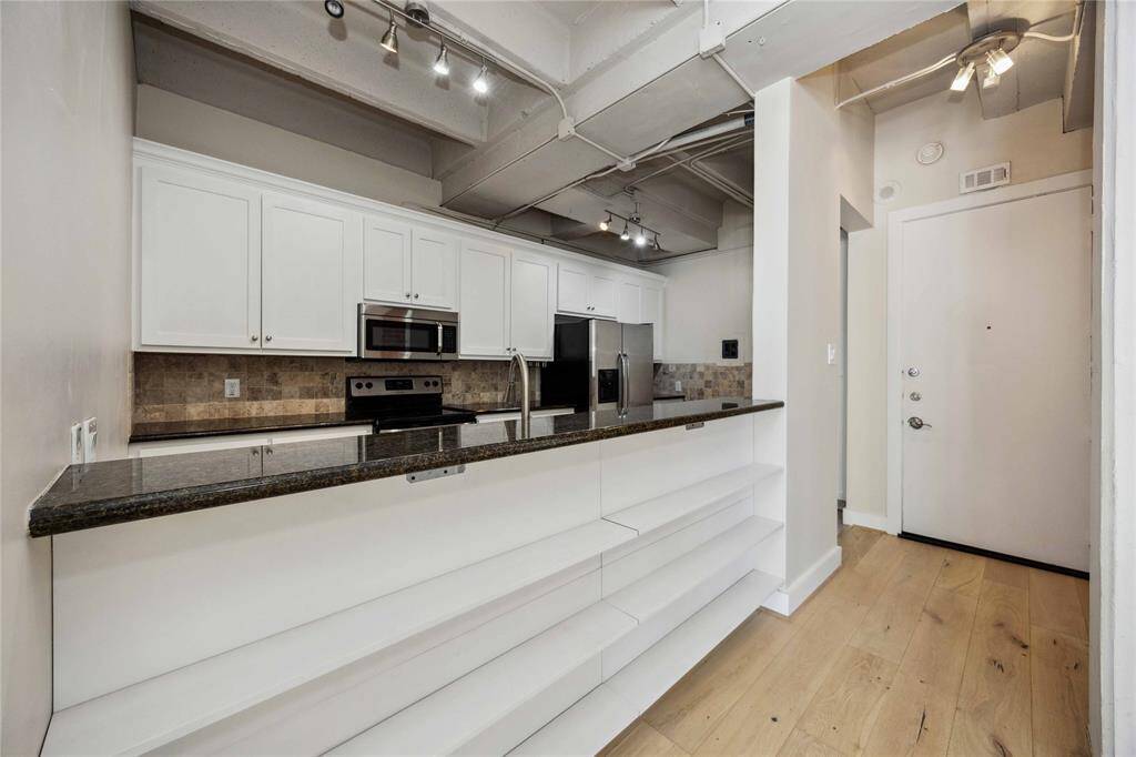 Built-in shelving just under the bar separates the living room and kitchen.