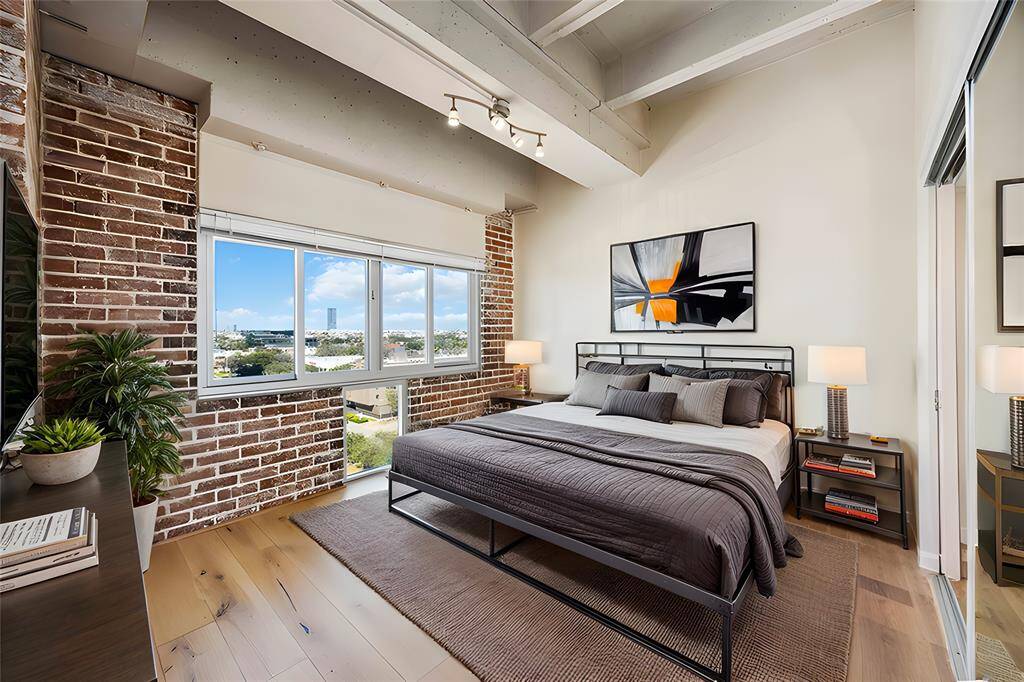 You'll love relaxing in this elegant, sophisticated bedroom. Resting under high ceilings and offering an incredible outdoor view, this bedroom is a real showcase! *Virtually staged photo
