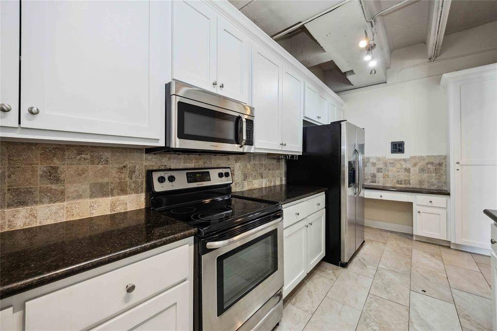There is plenty of counter space to create your favorite meals, including a built-in desk area ideal for weekly meal planning. The refrigerator conveys with the home.