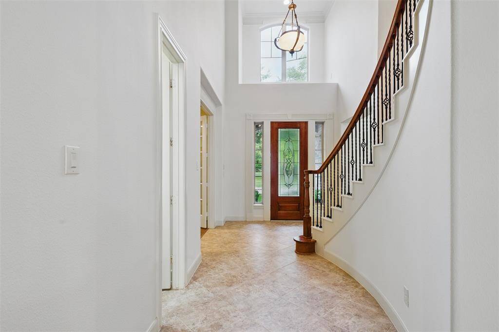 Grand 2 story entry that leads into the living room. Powder room is just off to the side of the entry past the study.