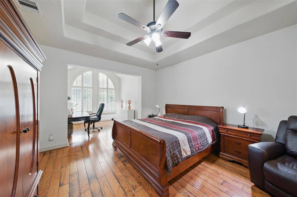 Master suite with tray ceiling and separate sitting area.