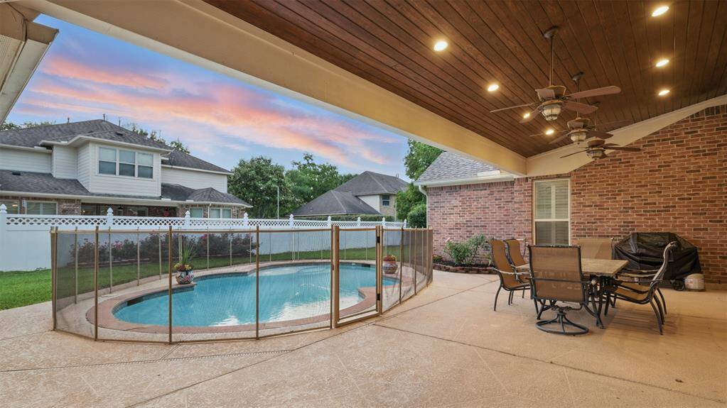 Take a rest from your dip in the pool underneath the large covered patio with tongue and groove ceiling.