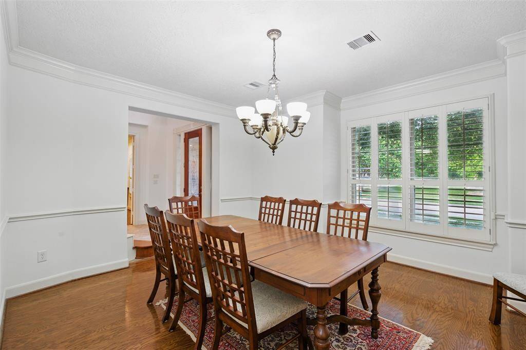 The formal dining room is just to your left as you enter the home. It has rich hardwood floors, crown molding and a chair rail.