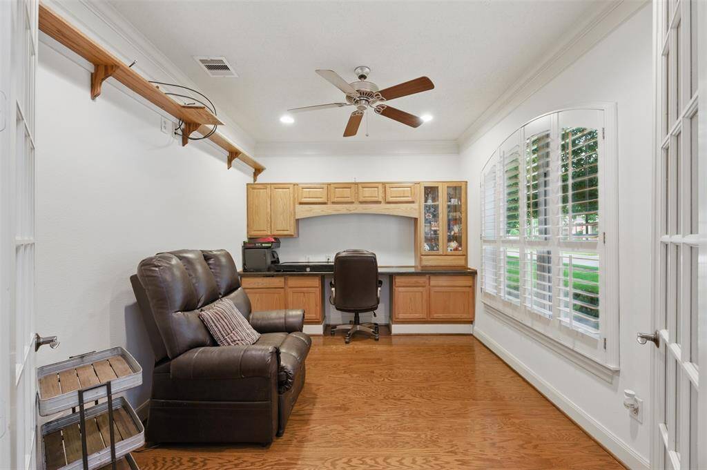 To your right as you enter the home, you will find the private study also with rich hardwoods and crown molding. A built-in desk and glass paneled French doors completes the space.