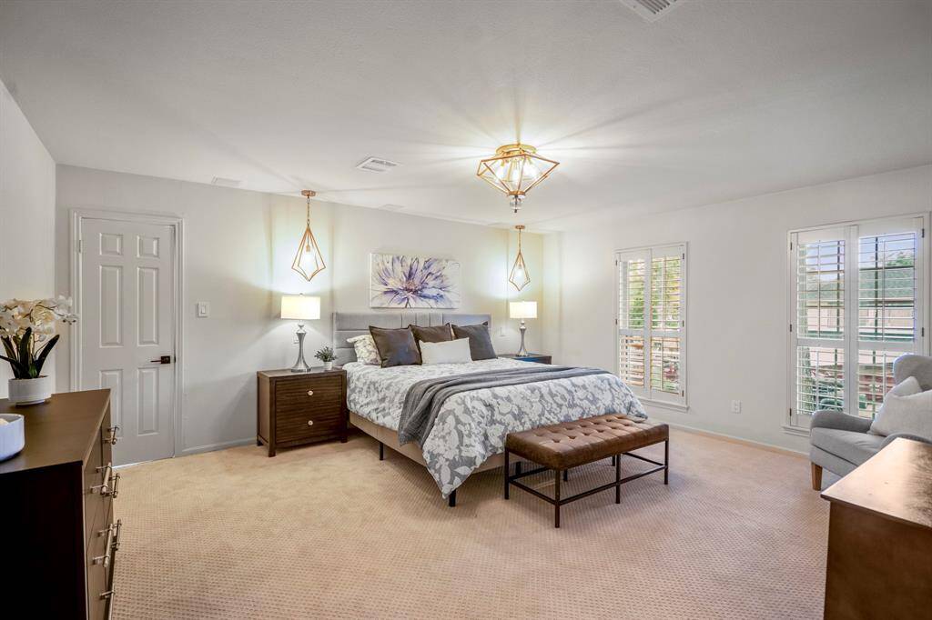 The owners suite offer a huge spacious bedroom with custom lighting, beautiful large windows with plantation shutters looking out onto the beautiful backyard.