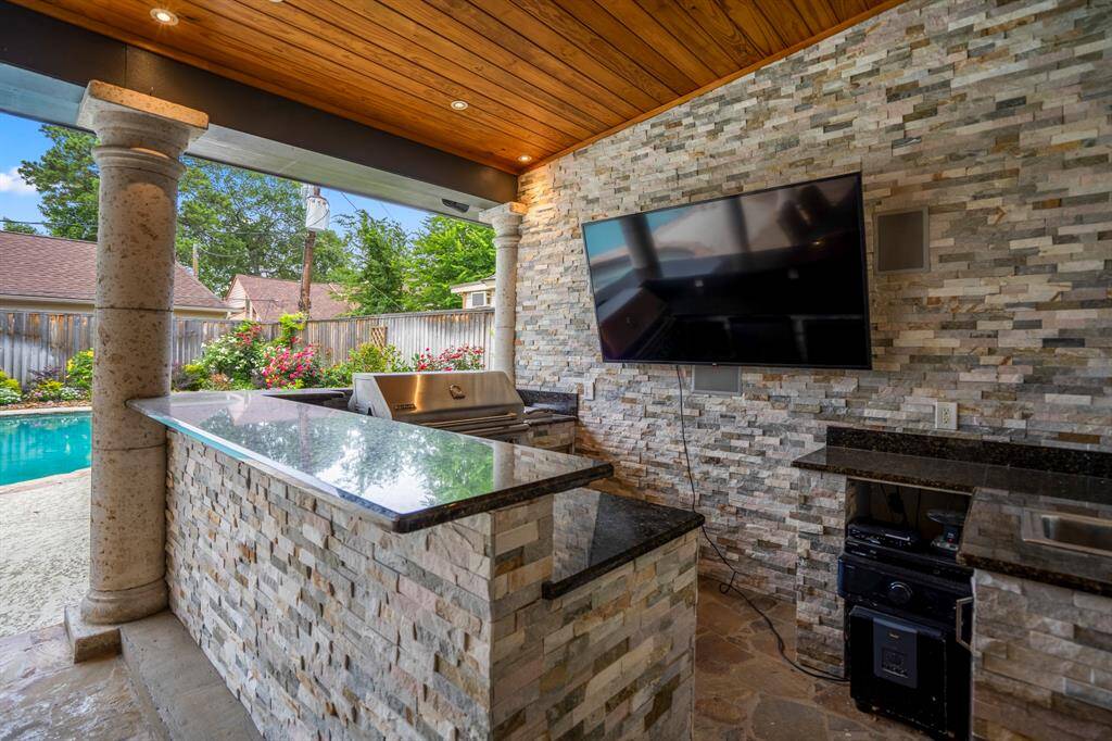 The bar area offers a fun experience for the host as well as the guests, with everything you could possibly need to enjoy this beautiful backyard oasis.