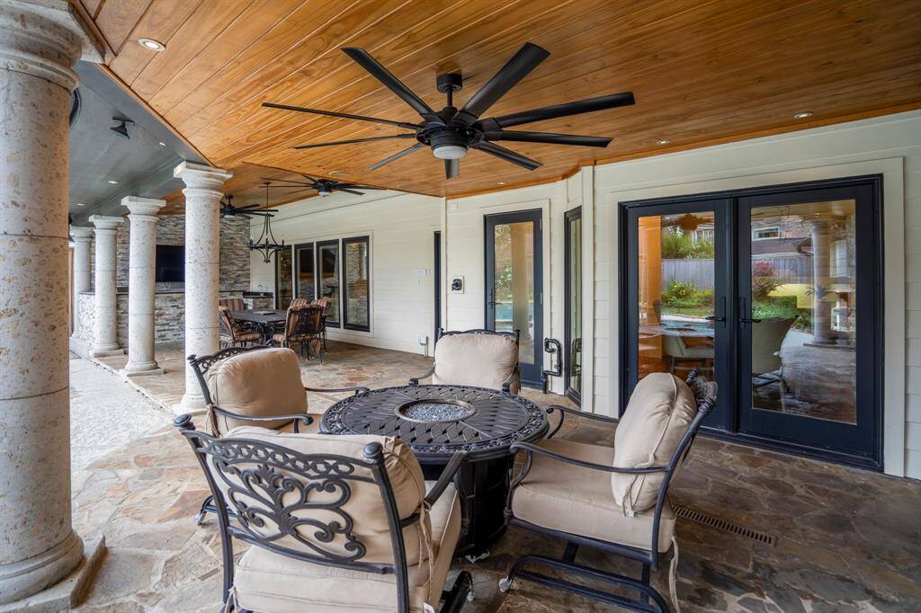 The covered patio area offers several areas for seating, majestic columns that elevate the outdoors and three huge outdoor fans.  The rear doors are shatterproof with three-way locking mechanisms.