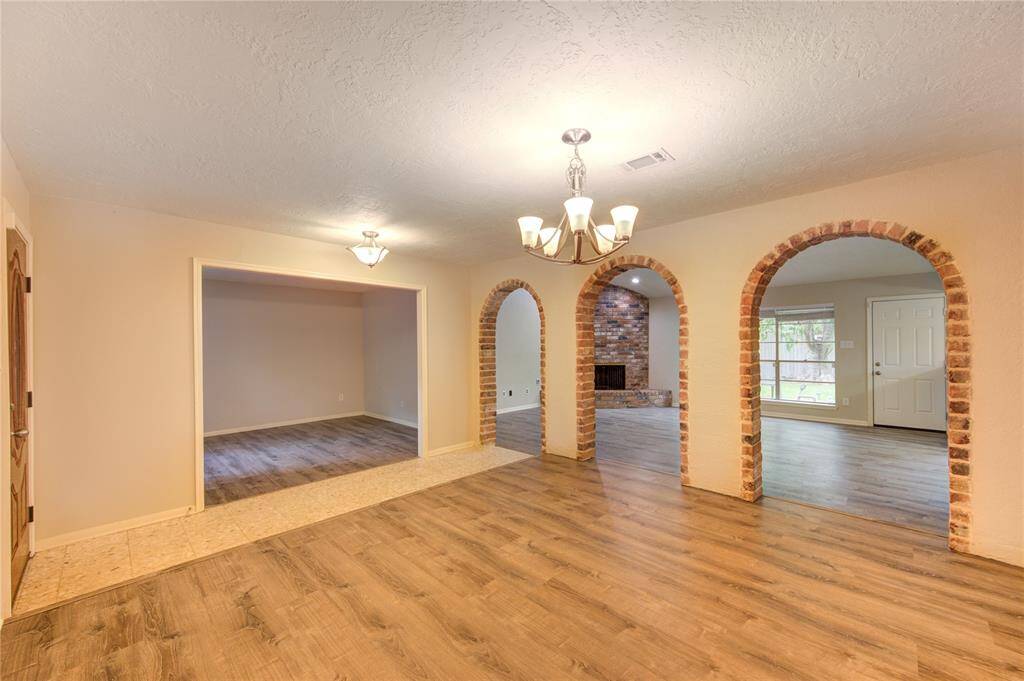 A great line of sight from the formal dining room into the formal living and family rooms enhances the home's open and inviting atmosphere. These rooms are adorned with high-end vinyl plank flooring that offers the perfect blend of beauty and resilience.