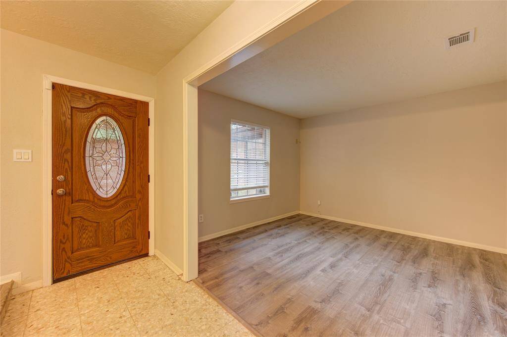 As you enter the home, you're welcomed by a foyer flanked by both the formal living and dining rooms, creating a warm and inviting first impression.
