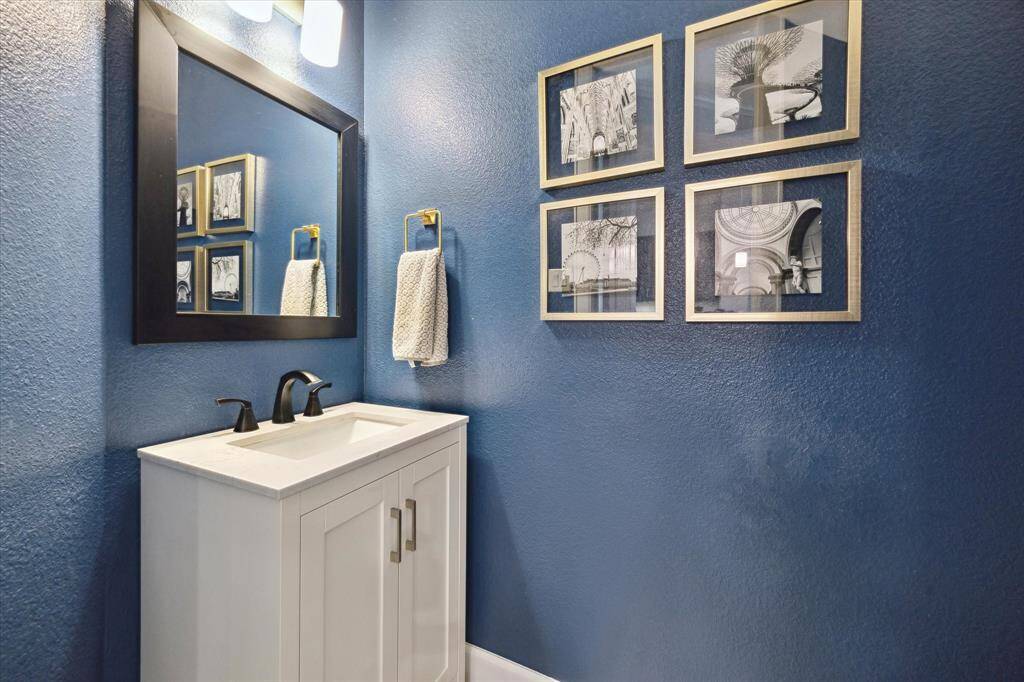 Bold and dramatic is this first floor half bath (7x3) with customized sink with storage below.