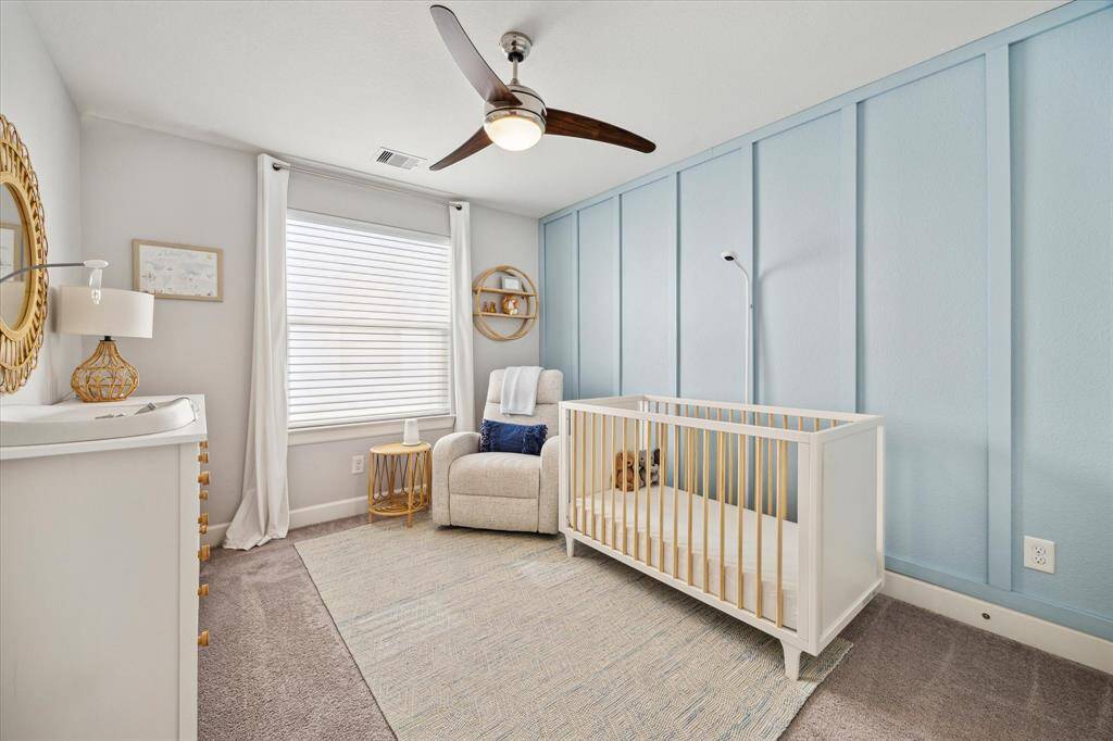 Secondary bedroom (12x10) with ceiling fan, great light and custom wall.