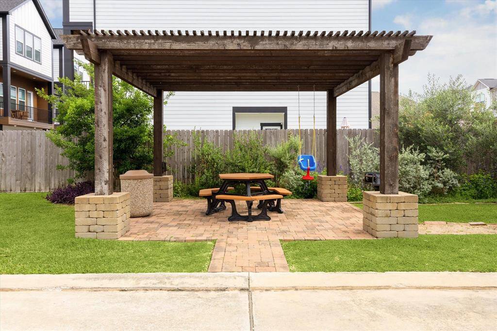 Outdoor community grill/dining area complete with child swing! To the left of this area is the abundant green space in next photo.