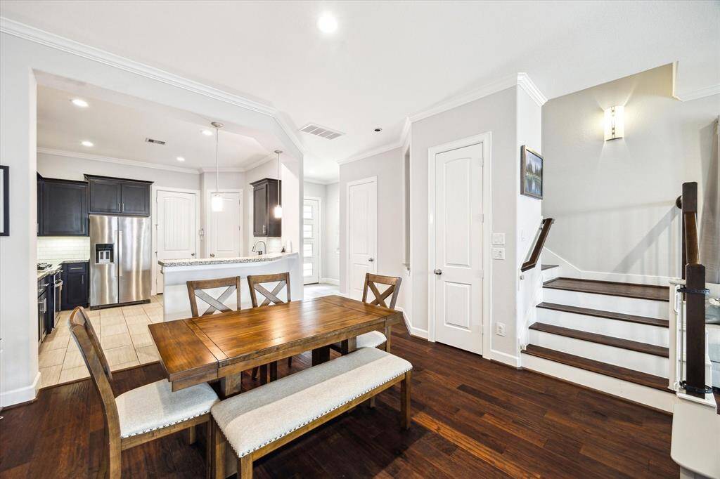 Dining area conveniently located between the kitchen and living areas. Beautiful engineered wood flooring throughout living and dining areas.