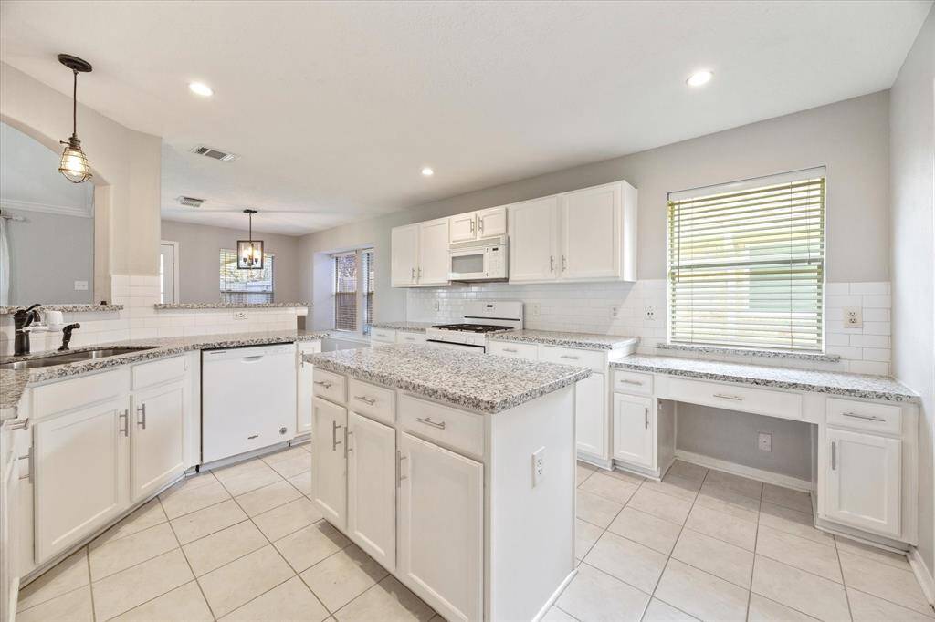 Bright kitchen with an island and gas range