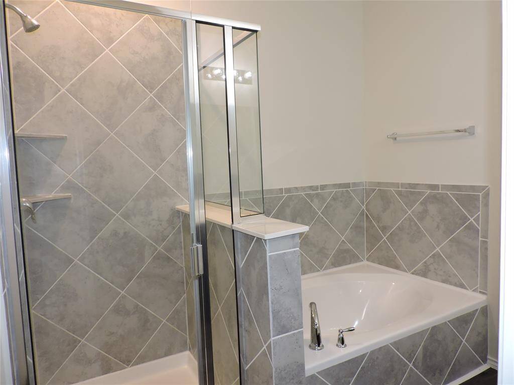 Walk in Shower and Soaking Tub with Ceramic Tile surrounds