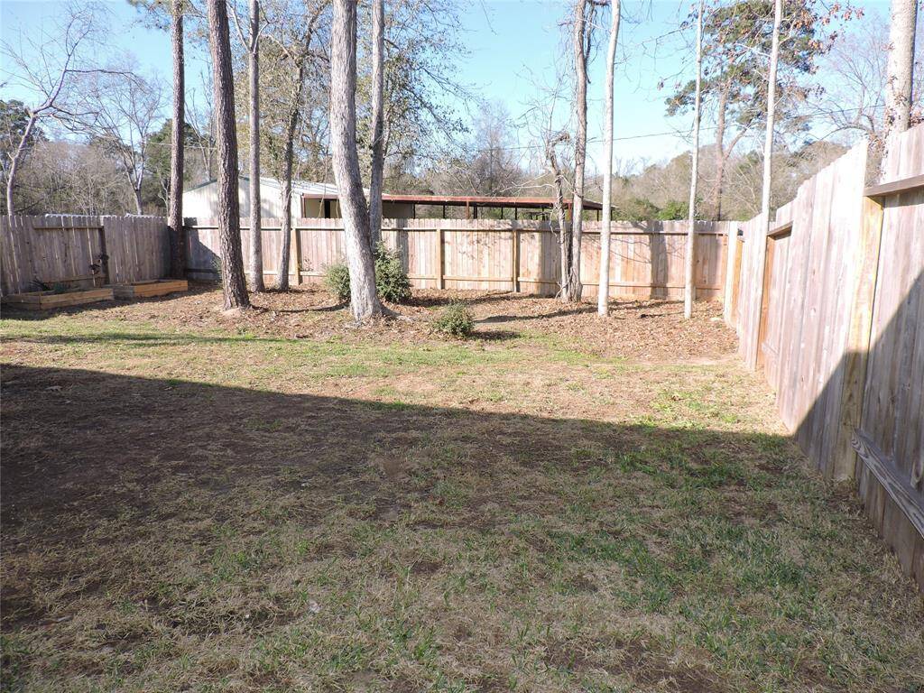 The large backyard is fenced