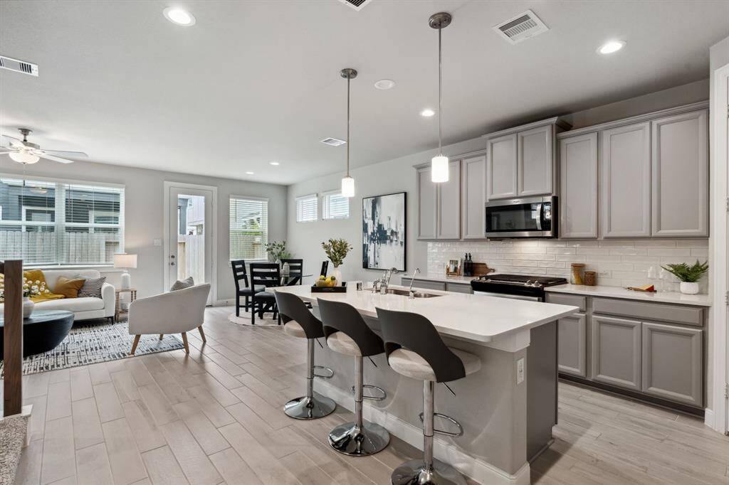 The focal point is a sleek island thatnot only provides additional counterspace but also serves as a casualgathering spot.