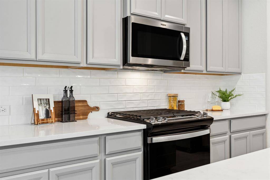 There is also modern white backsplash in the kitchen.