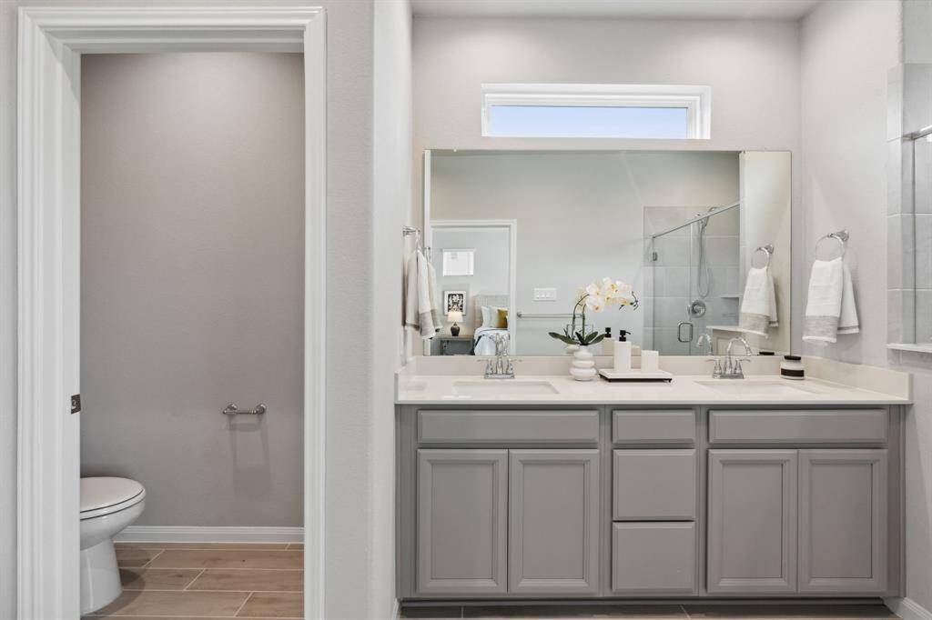 The first primary bathroom features dual sinks.