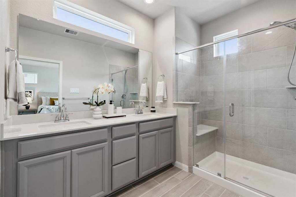 There is also a spacious walk-in shower with tile surround and sitting area.