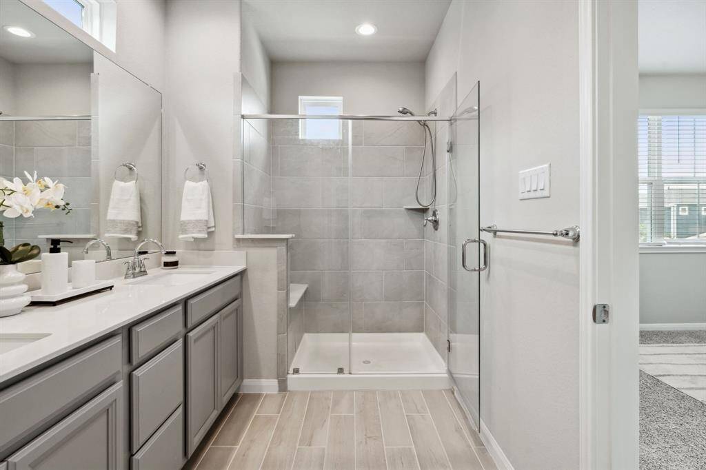 There is also a spacious walk-in shower with tile surround and sitting area.