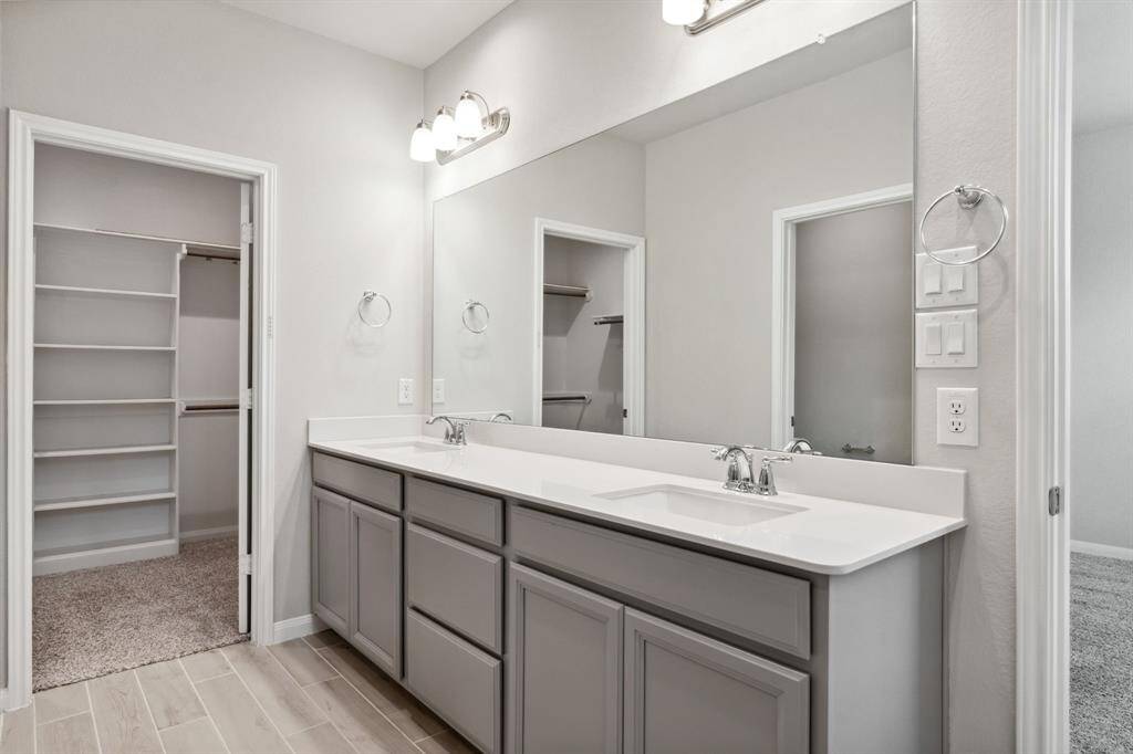 The second primary bathroom features dual sinks.