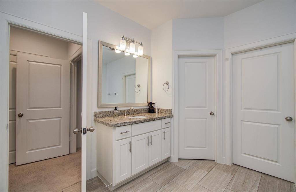Separate vanity in the primary bathroom.