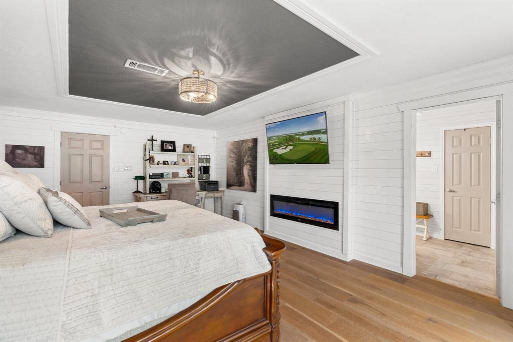 Cozy fireplace enhances the charm of the primary suite.