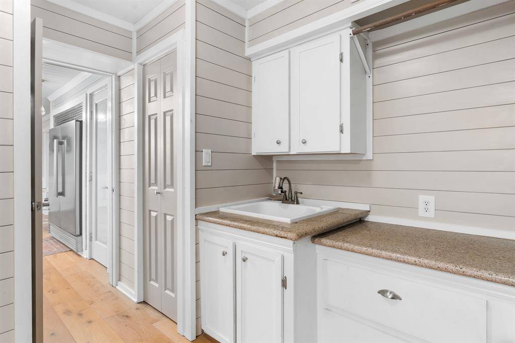 Spacious laundry mudroom with convenient sink.