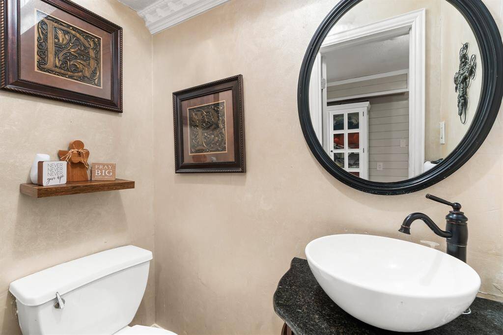 Chic and convenient downstairs half bath with modern fixtures and elegant decor.