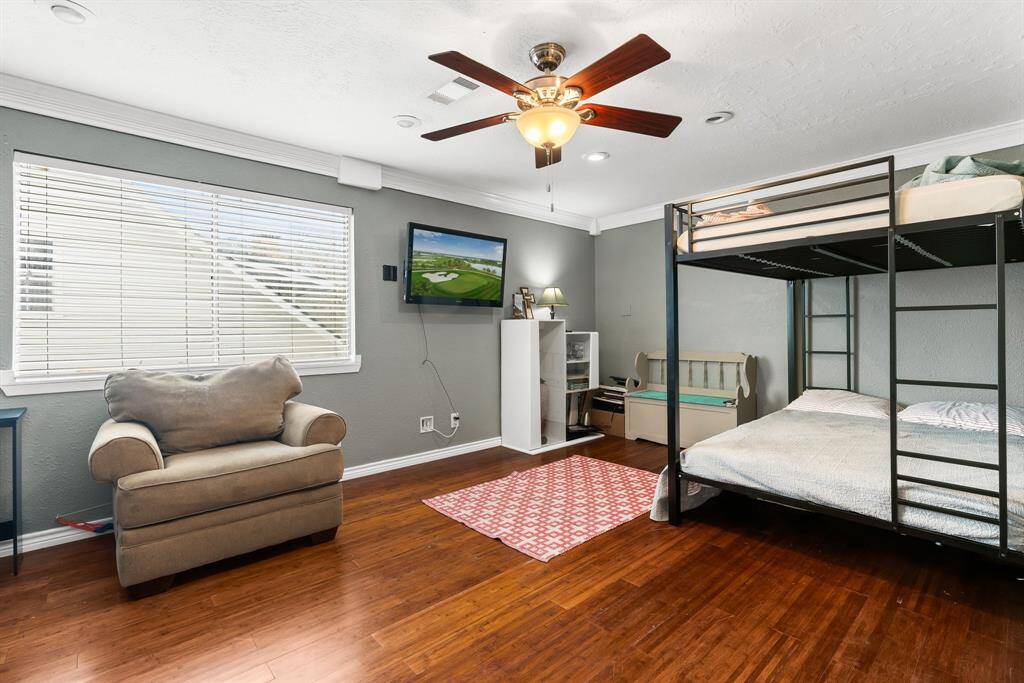 Spacious upstairs bedroom with ample natural light and versatile space for relaxation or study.