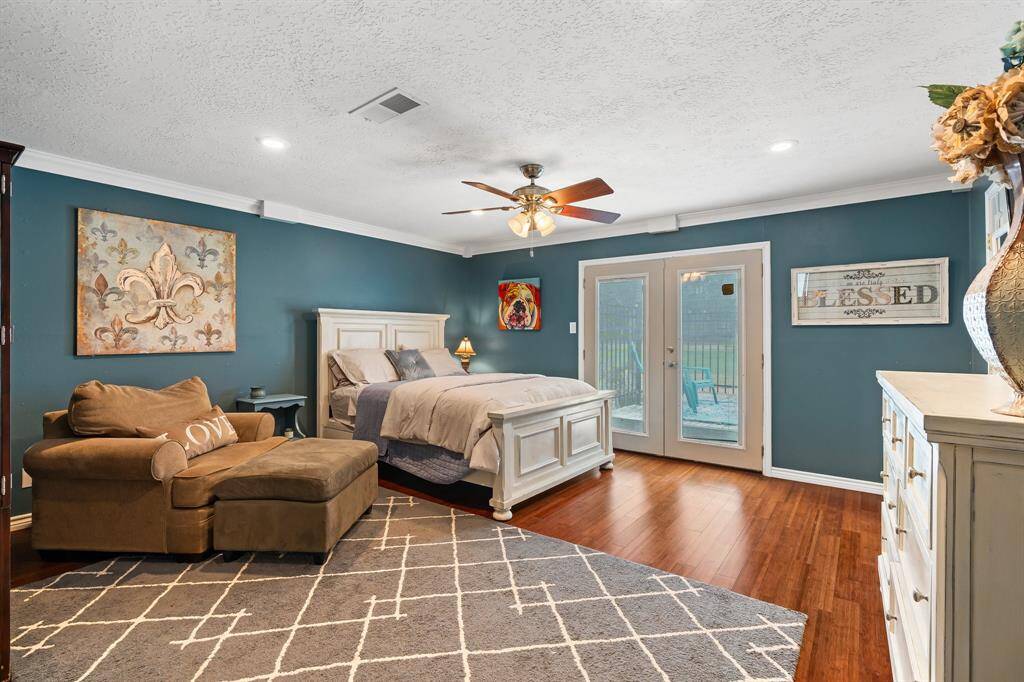 Expansive upstairs bedroom with a private balcony for serene views.