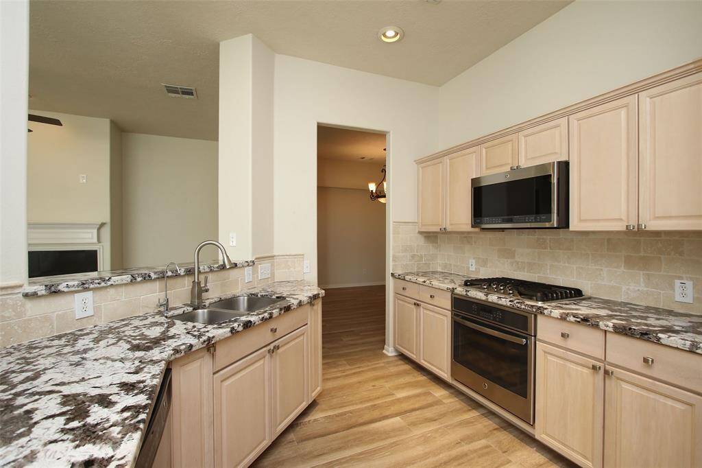 Updated Kitchen with Granite Counters and Stainless Appliances.