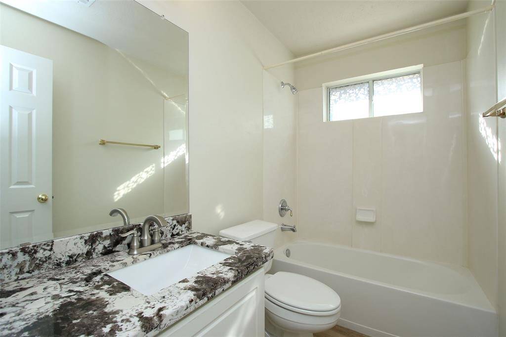 Full Bath with Granite Counter and Tub Shower Combo.