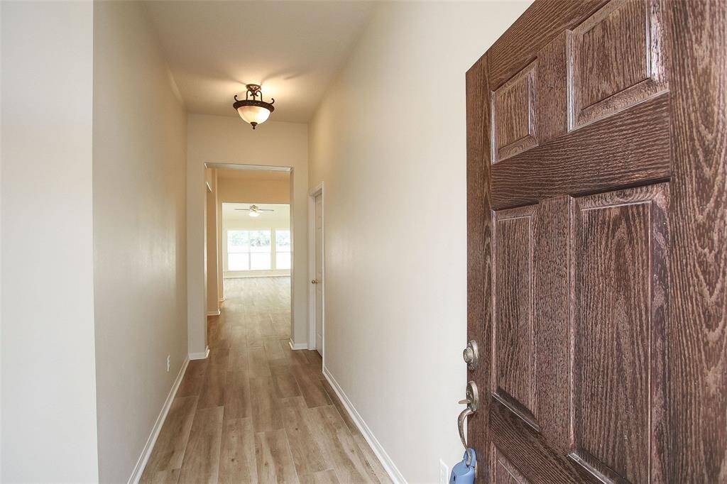 Beautiful Entry with Extensive Updated Wood Look Tile Flooring Throughout.  There is Now a New Leaded Glass Wood Door.
