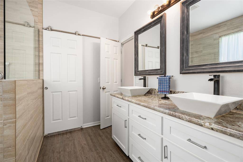 Fully updated primary bath with granite countertops.