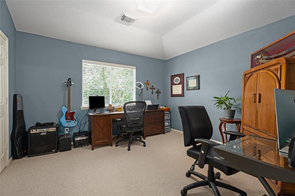 Upstairs Bedroom that can easily be used as an office. The window overlooks the gorgeous wooded retreat in your backyard.