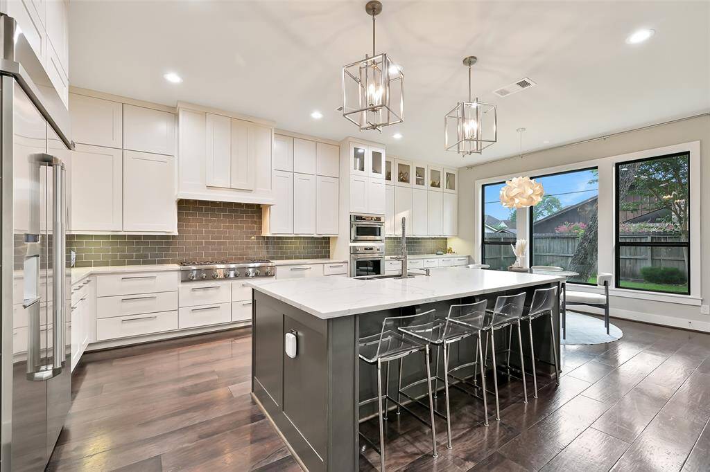 Another view of the kitchen shows breakfast area and backyard view.