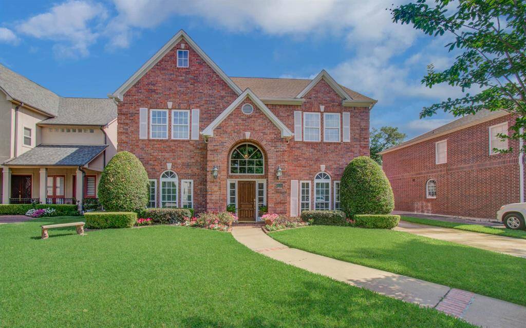 This classic brick home offers great curb appeal with its manicured landscaping and abundant double paned windows.