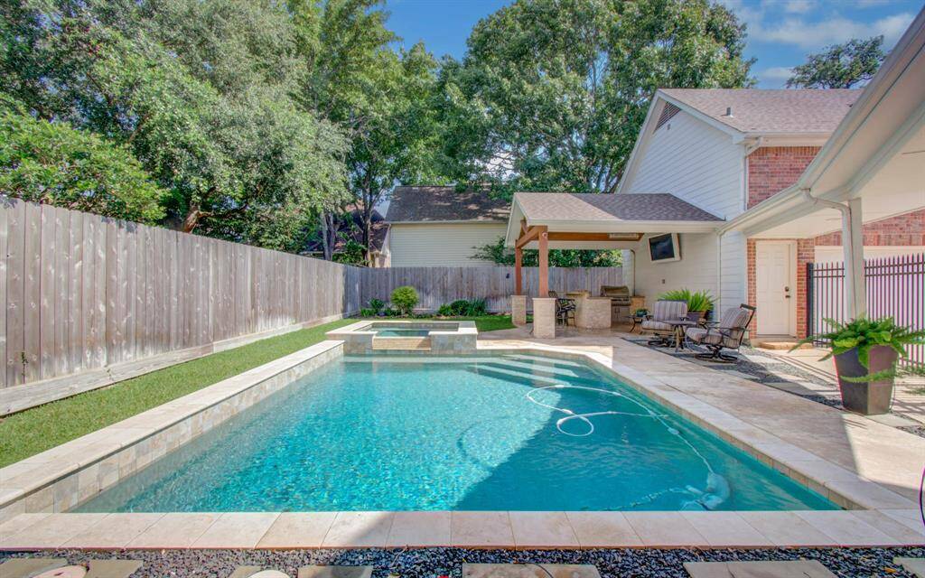 Sparkling pool and hot tub are a generous size, but there is still lawn space in the back as well as a giant front yard