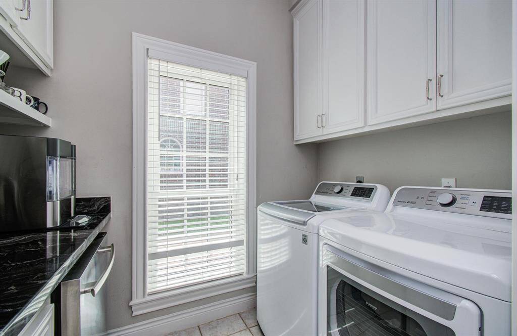 The utility room also offers space for additional small appliances, as well as another beverage refrigerator and plenty of storage in the cabinets on both sides