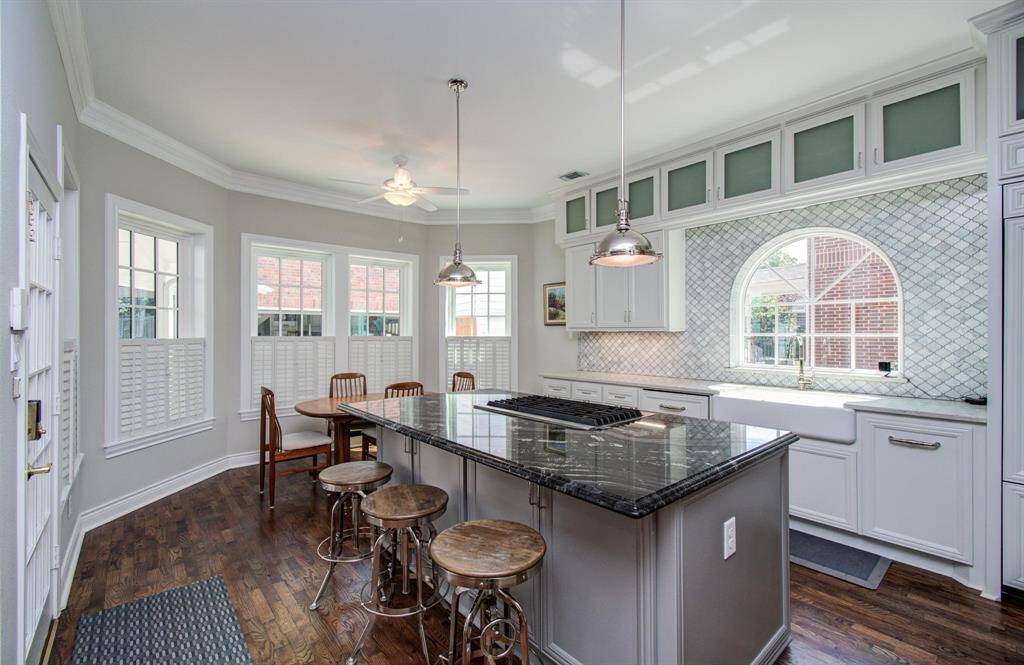 Beautiful kitchen with a large breakfast area and abundant natural light. Custom cabinetry including paneled appliances
