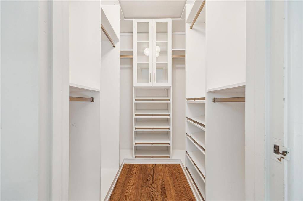 Spacious walk-in primary closet renovated by California Closets. There is another closet in the primary done by California Closets as well!