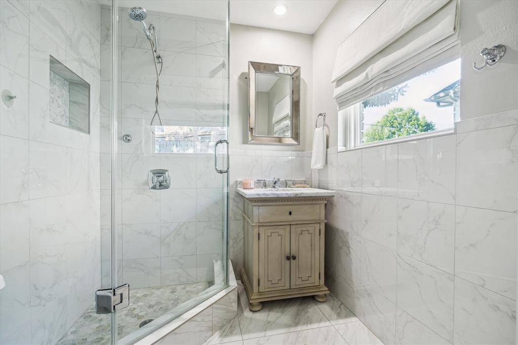 Beautifully updated primary bathroom with a walk-in shower.