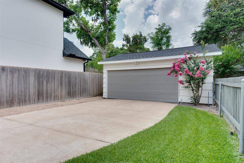 Two car garage with full driveway to the left of the home.