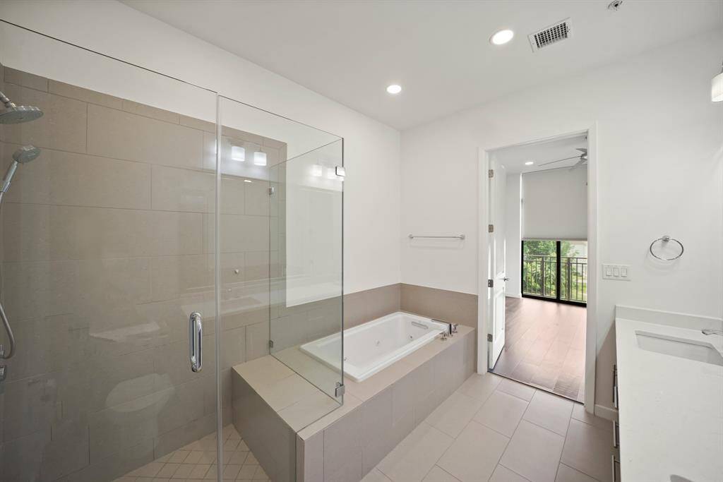 Primary bath with oversized shower and separate tub.