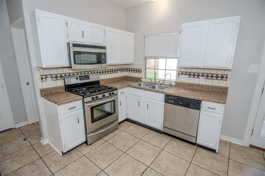 igh Ceilings in the Kitchen with Stainless Steel Appliances