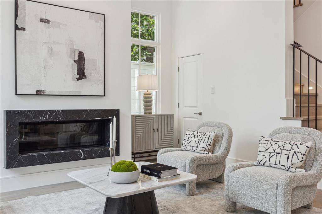 Linear floating fireplace with stone surround is another one of the many upgrade options available to make this space your own.