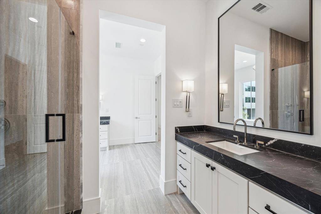 Second vanity space also has an oversized mirror and additional storage.